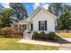 Charming one-story home with white siding, black shutters, and landscaped front yard at 408 Flagg Rd, Holly Springs, NC 27540