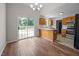 Open kitchen with stainless steel appliances, breakfast bar, and sliding glass doors to the outdoor deck at 408 Flagg Rd, Holly Springs, NC 27540