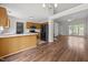 Open-concept kitchen with stainless steel appliances, breakfast bar, and hardwood floors at 408 Flagg Rd, Holly Springs, NC 27540