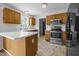 Bright kitchen features stainless steel appliances, ample wood cabinetry and modern countertops at 408 Flagg Rd, Holly Springs, NC 27540