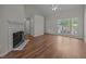 Bright living room with large windows, fireplace, and hardwood floors at 408 Flagg Rd, Holly Springs, NC 27540