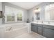 A spacious bathroom features a soaking tub, double sinks and ample natural light from the window at 408 Heritage Village Ln, Apex, NC 27502