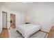 A sunlit bedroom featuring a patterned rug and bed, with a lamp and side table at 408 Heritage Village Ln, Apex, NC 27502