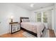 Comfortable bedroom featuring a ceiling fan, a decorative patterned nightstand, and plenty of natural light at 408 Heritage Village Ln, Apex, NC 27502