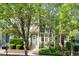 Inviting two-story townhome with a charming front porch, lush greenery, and a well-manicured lawn at 408 Heritage Village Ln, Apex, NC 27502