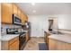 Functional kitchen with stainless steel appliances, ample counter space, and abundant cabinet storage at 408 Heritage Village Ln, Apex, NC 27502