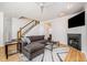 Stylish living room featuring a cozy fireplace, plush sectional sofa, and hardwood floors with plenty of natural light at 408 Heritage Village Ln, Apex, NC 27502