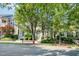 Charming townhomes line the street with beautiful landscaping and mature trees in a well-maintained neighborhood at 408 Heritage Village Ln, Apex, NC 27502
