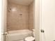 Bathroom features tub and shower combo with tiled surround and built-in niche at 411 Gooseneck Dr # A1, Cary, NC 27513