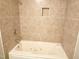 Bathroom features a soaking tub with tiled surround and recessed niche at 411 Gooseneck Dr # A1, Cary, NC 27513