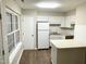 This kitchen features a breakfast bar, and bright white cabinetry at 411 Gooseneck Dr # A1, Cary, NC 27513