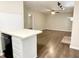 View of the kitchen featuring bar seating and new floors at 411 Gooseneck Dr # A1, Cary, NC 27513