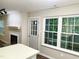 View of the living room featuring a cozy fireplace and natural lighting at 411 Gooseneck Dr # A1, Cary, NC 27513