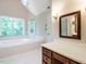 Bathroom featuring a large soaking tub, vanity, and tile floors at 4204 Thetford Rd, Durham, NC 27707