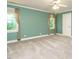 Spacious bedroom with ample natural light from large windows and neutral decor at 4204 Thetford Rd, Durham, NC 27707