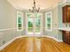 Bright dining area with natural light, wooden floors and access to a back deck at 4204 Thetford Rd, Durham, NC 27707