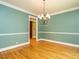 Large dining room with hardwood floors, modern lighting, and lots of natural light at 4204 Thetford Rd, Durham, NC 27707