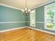 Formal dining room with hardwood floors, decorative lighting, and elegant finishes at 4204 Thetford Rd, Durham, NC 27707