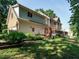 Back exterior showcasing a large yard, brick and light siding, and a wooden deck at 4204 Thetford Rd, Durham, NC 27707