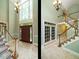 Spacious foyer with soaring ceilings, tiled floors, and a grand staircase at 4204 Thetford Rd, Durham, NC 27707