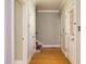 Hallway with hardwood floors, multiple doors, and access to stairs at 4204 Thetford Rd, Durham, NC 27707