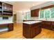 Spacious kitchen with wooden floors, a center island, and breakfast area at 4204 Thetford Rd, Durham, NC 27707
