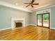 Bright living room with hardwood floors, fireplace and doors leading to the deck at 4204 Thetford Rd, Durham, NC 27707