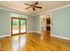 Sunlit living room showcasing hardwood floors and doors to the outdoor deck at 4204 Thetford Rd, Durham, NC 27707