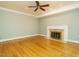Cozy living room featuring hardwood floors, a fireplace, and neutral paint colors at 4204 Thetford Rd, Durham, NC 27707