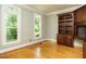 Bright and airy office space with hardwood floors, built-in shelving, and large windows at 4204 Thetford Rd, Durham, NC 27707