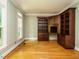 Office featuring built-in bookshelves, desk, hardwood floors and natural light at 4204 Thetford Rd, Durham, NC 27707