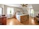 Bright bedroom with natural light, hardwood floors, and a decorative ceiling fan at 4702 Pleasant Green Rd, Durham, NC 27705