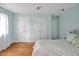 Light filled bedroom featuring three closets, hardwood flooring and neutral decor at 4702 Pleasant Green Rd, Durham, NC 27705