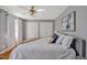 Comfortable bedroom featuring a ceiling fan, white linens, and natural light at 4702 Pleasant Green Rd, Durham, NC 27705