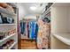 Walk-in closet featuring hardwood floors and custom shelving for optimal organization at 4702 Pleasant Green Rd, Durham, NC 27705
