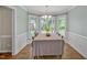 Charming dining room with bay windows, a chandelier, and wainscoting at 4702 Pleasant Green Rd, Durham, NC 27705