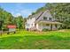 Charming two-story home with a red door, white siding, and a well-manicured lawn at 4702 Pleasant Green Rd, Durham, NC 27705