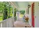 Cozy front porch with rocking chair and outdoor seating, perfect for enjoying the surroundings at 4702 Pleasant Green Rd, Durham, NC 27705