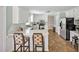 Modern kitchen with white cabinets, tiled floors, and stainless steel appliances at 4702 Pleasant Green Rd, Durham, NC 27705