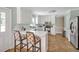 Stylish kitchen with white cabinets, stainless appliances, and bar seating at 4702 Pleasant Green Rd, Durham, NC 27705