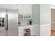 Cozy kitchen featuring white cabinets, a stainless steel refrigerator, and a built-in desk at 4702 Pleasant Green Rd, Durham, NC 27705