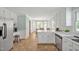 Bright eat-in kitchen with white cabinets, stainless appliances, and tiled floors at 4702 Pleasant Green Rd, Durham, NC 27705