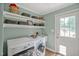 Well-organized laundry room featuring modern washer and dryer, shelving and exterior access at 4702 Pleasant Green Rd, Durham, NC 27705
