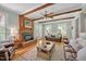 Inviting living room with brick fireplace, hardwood floors, ceiling fan, and comfortable seating at 4702 Pleasant Green Rd, Durham, NC 27705