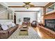 Cozy living room featuring exposed ceiling beams, a fireplace, and comfortable seating at 4702 Pleasant Green Rd, Durham, NC 27705