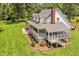 Spacious home showcasing a screened-in porch and landscaped backyard, ideal for outdoor living at 4702 Pleasant Green Rd, Durham, NC 27705
