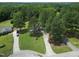 Aerial view of a quaint home surrounded by lush greenery and mature trees in a serene setting at 50 Rainwood Ct, Louisburg, NC 27549