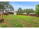 Spacious backyard featuring a privacy fence, lush green lawn, and a screened-in porch, ideal for outdoor enjoyment at 50 Rainwood Ct, Louisburg, NC 27549