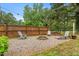 Backyard featuring gravel, a wood fence, lounge seating, and string lighting at 50 Rainwood Ct, Louisburg, NC 27549