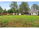 Vast backyard with an outbuilding, a privacy fence, mature trees, and a shed at 50 Rainwood Ct, Louisburg, NC 27549